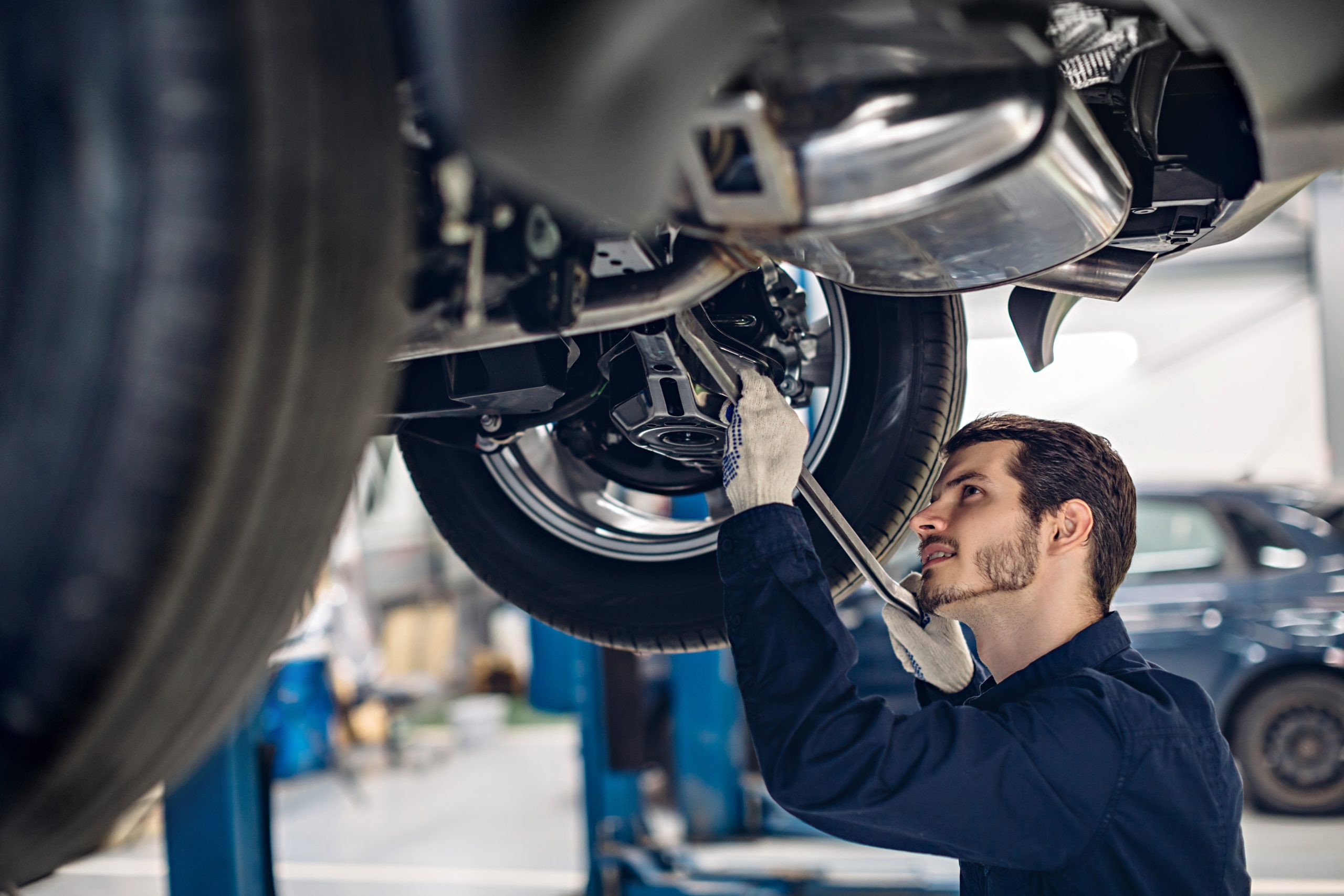 Service technician working on the underside of a vehicle